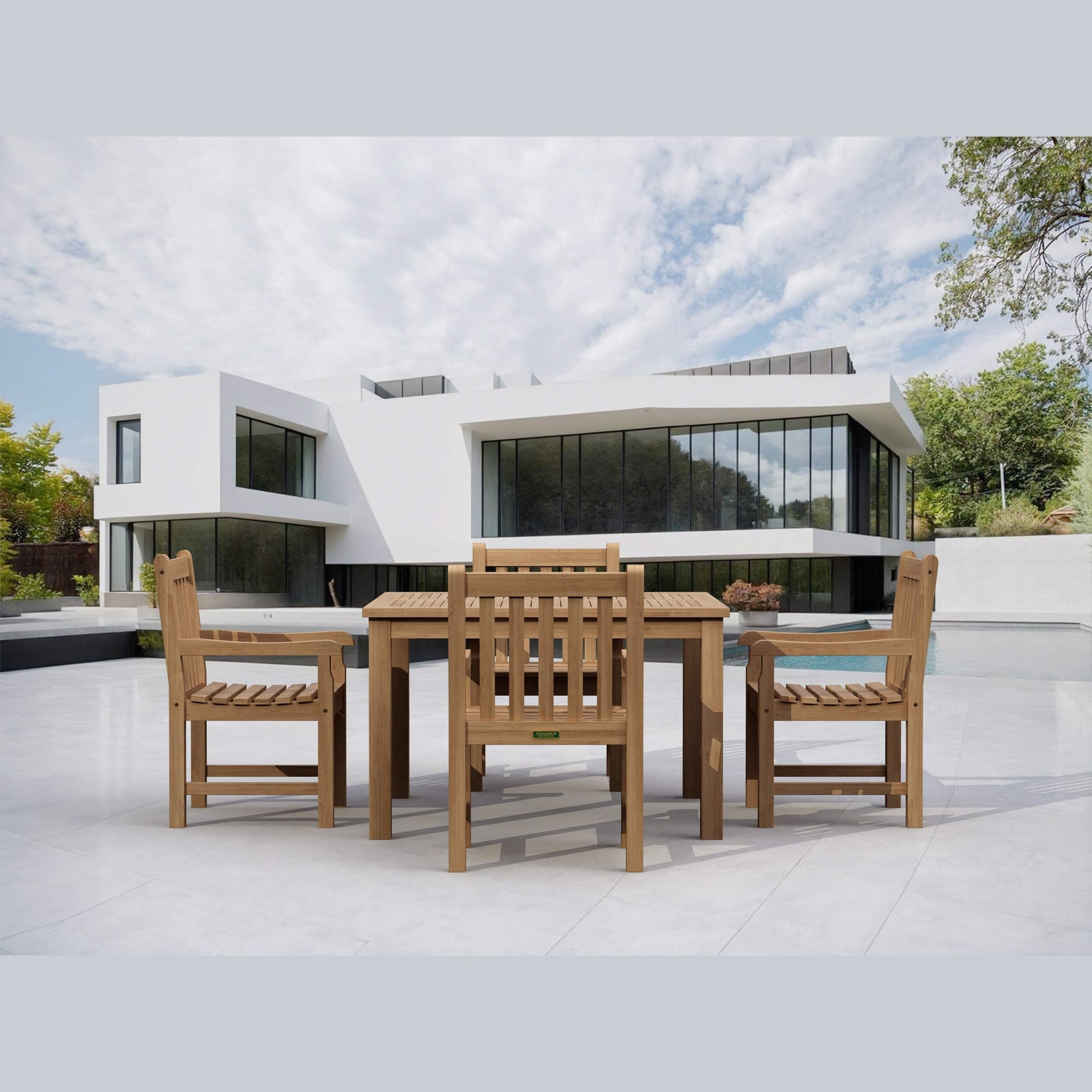 Wooden outdoor dining set with modern building and pool in the background