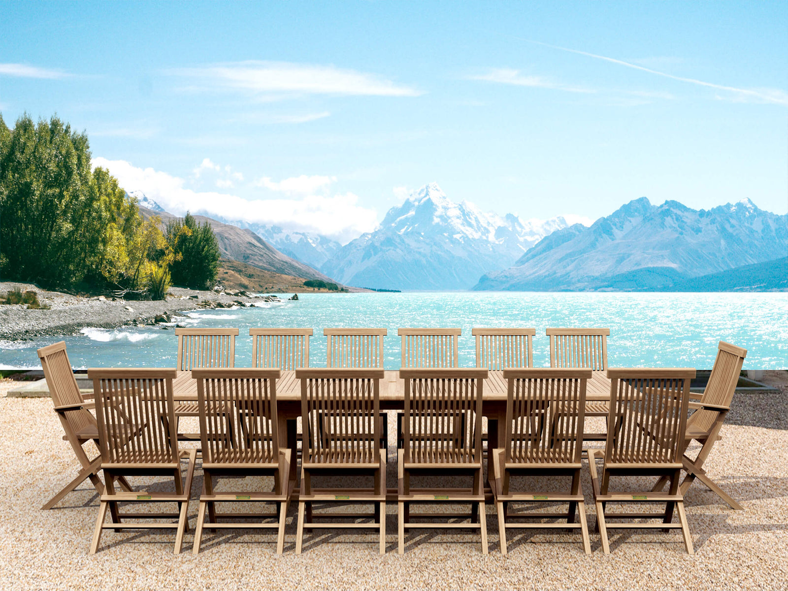 Wooden outdoor dining set with chairs by a lake and mountains