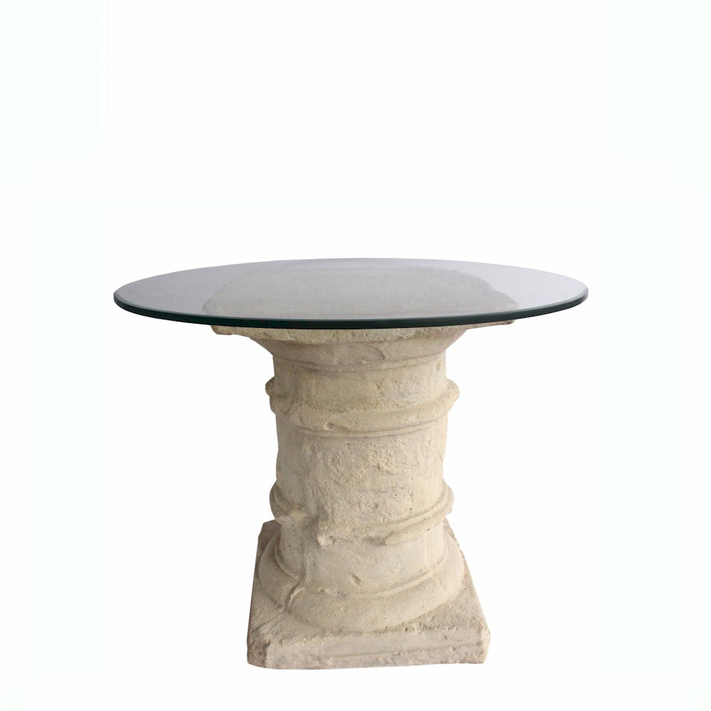 Round stone table with a glass top on a white background