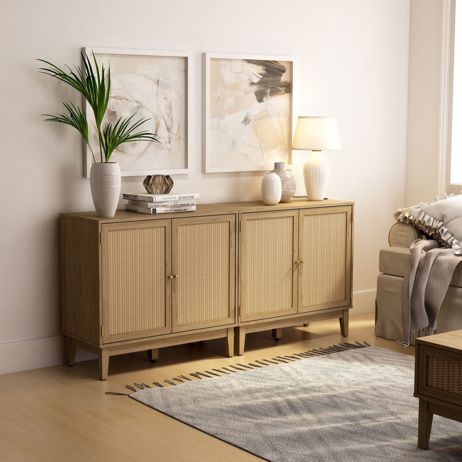 Wooden sideboard in a living room with decor items and a lamp.