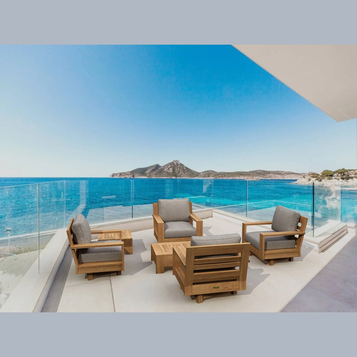 Outdoor furniture set on a balcony with a scenic view of the ocean and mountains.