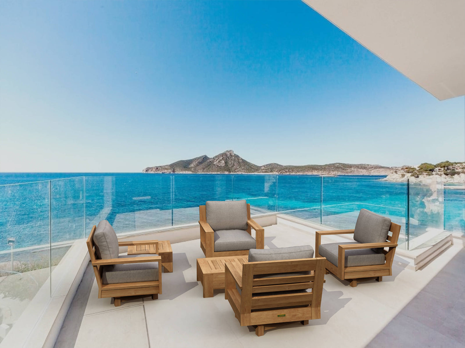 Outdoor furniture set on a balcony with a scenic view of the ocean and mountains.