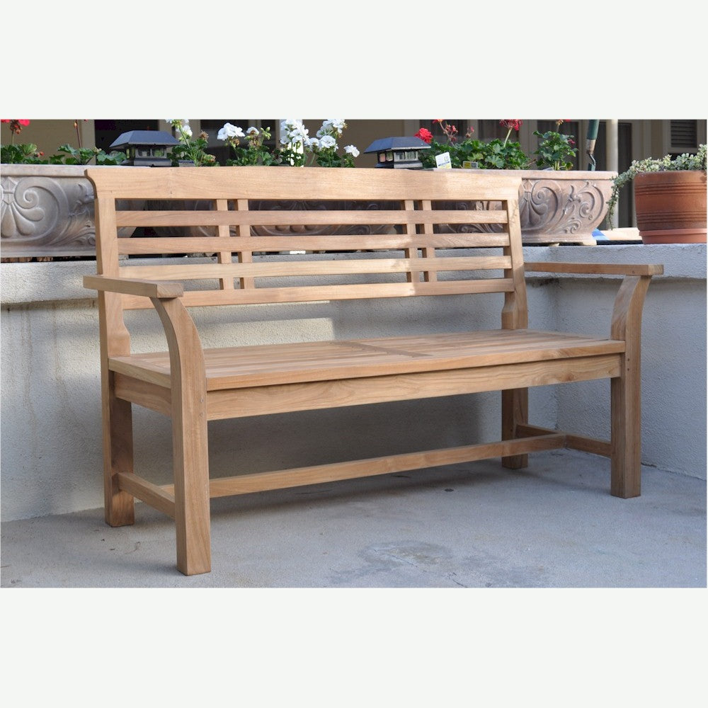 Wooden bench on a patio with decorative elements in the background