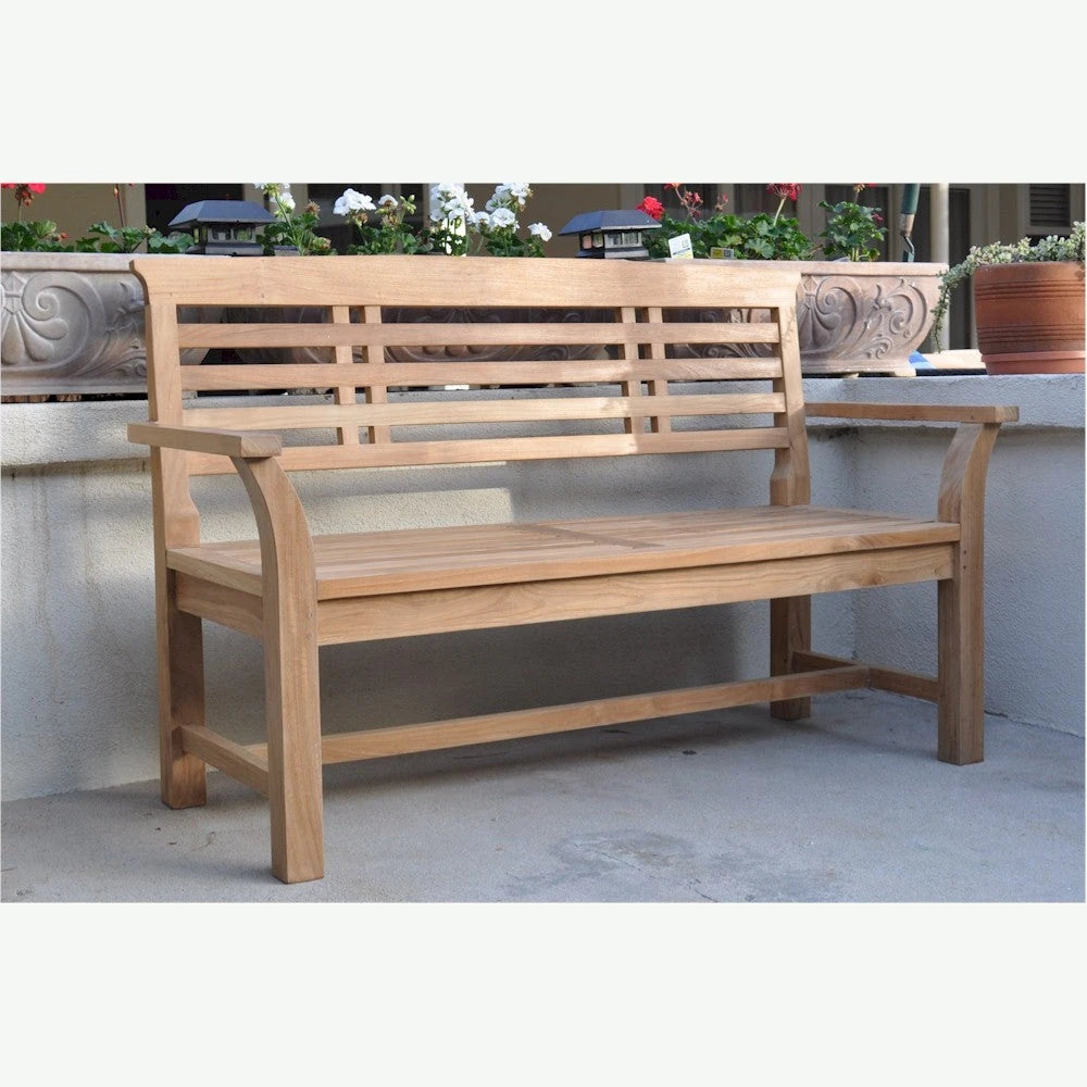 Wooden bench on a patio with decorative elements in the background
