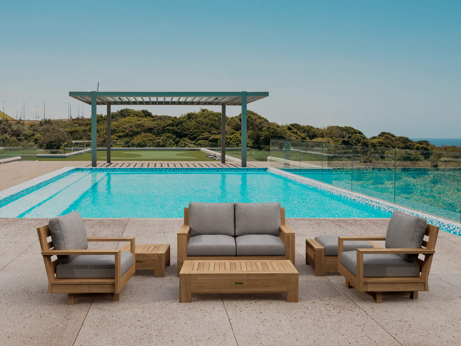 Outdoor patio furniture set with gray cushions by a pool