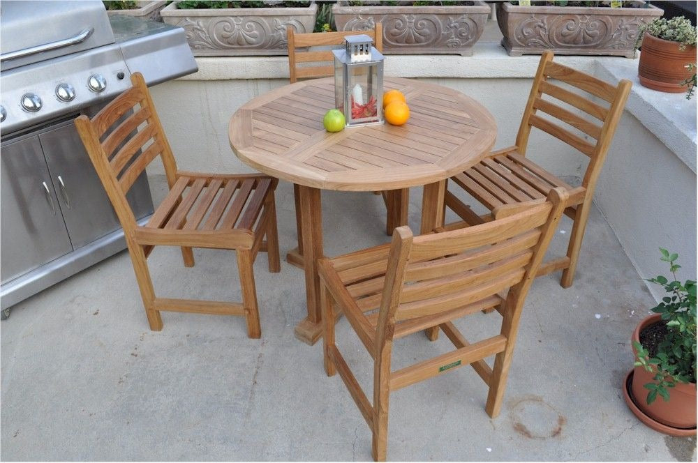 Wooden outdoor table with four chairs on a patio