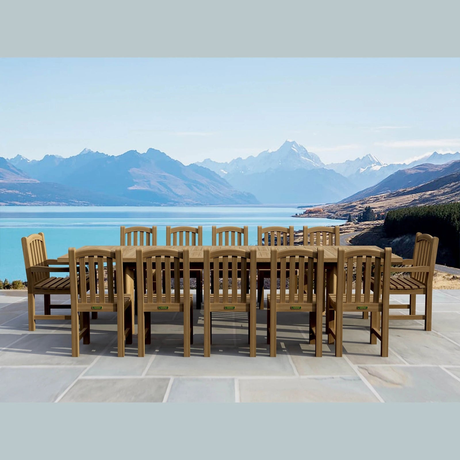 Wooden outdoor dining set with chairs and table in front of a scenic mountain and lake view.