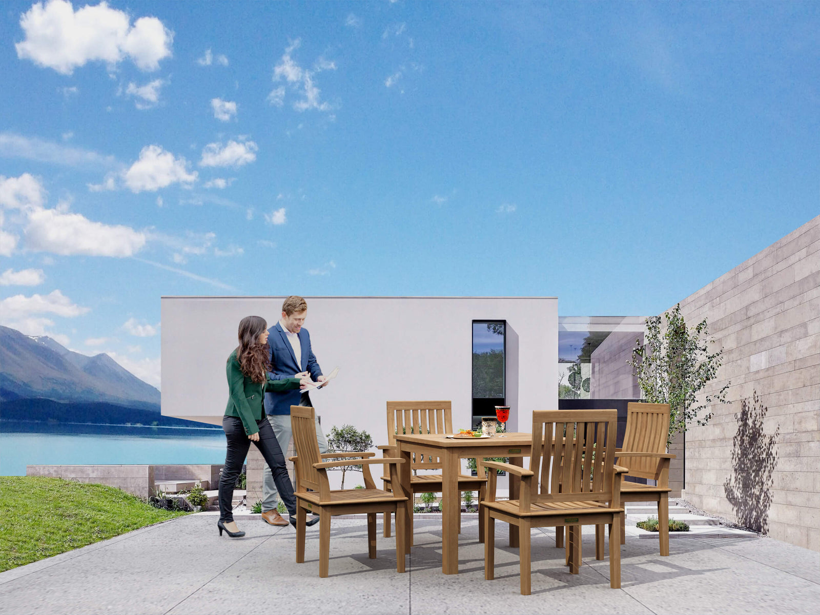 Two people standing near a wooden outdoor dining set with a scenic background.