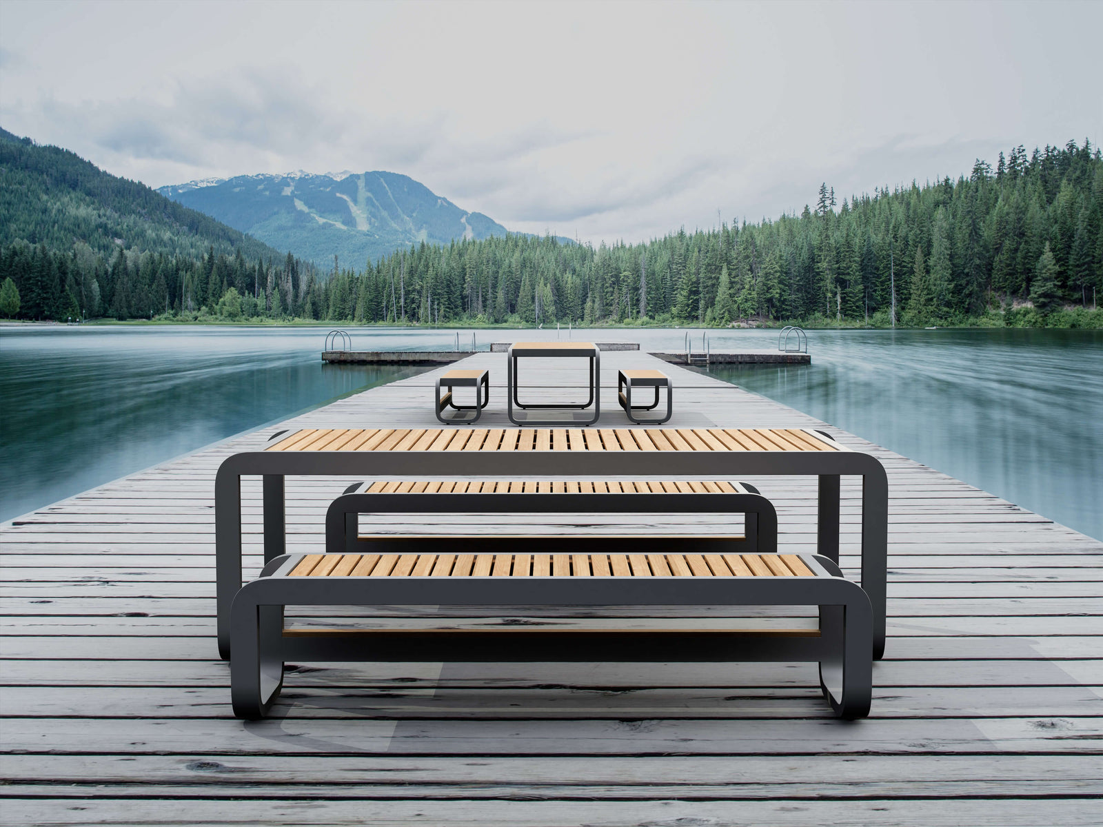 Wooden bench on a dock with a scenic view of mountains and trees.