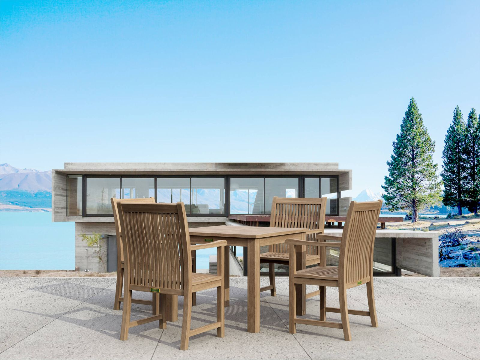 Outdoor dining set with table and chairs by a waterfront building.