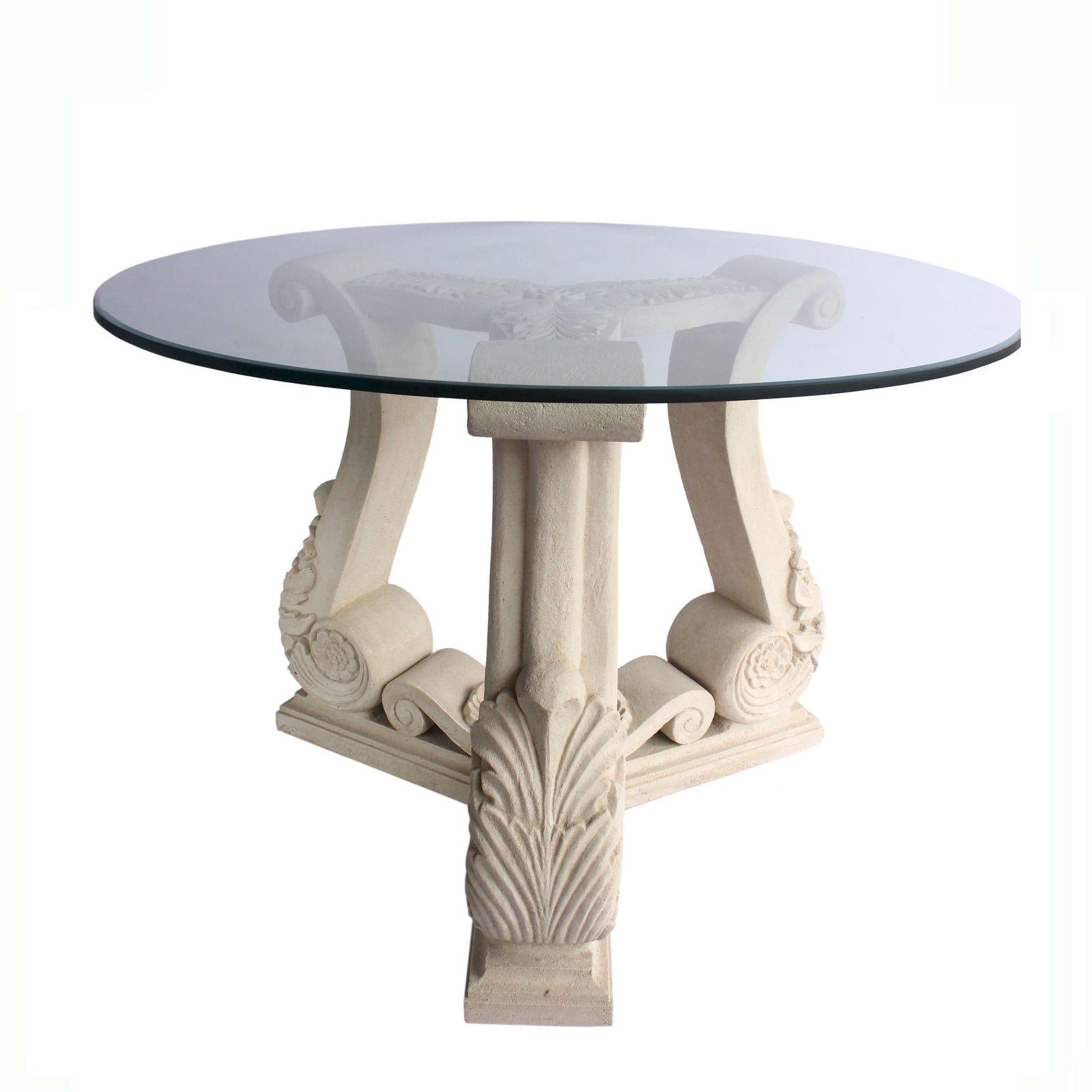 Round glass-top table with decorative white legs on a white background