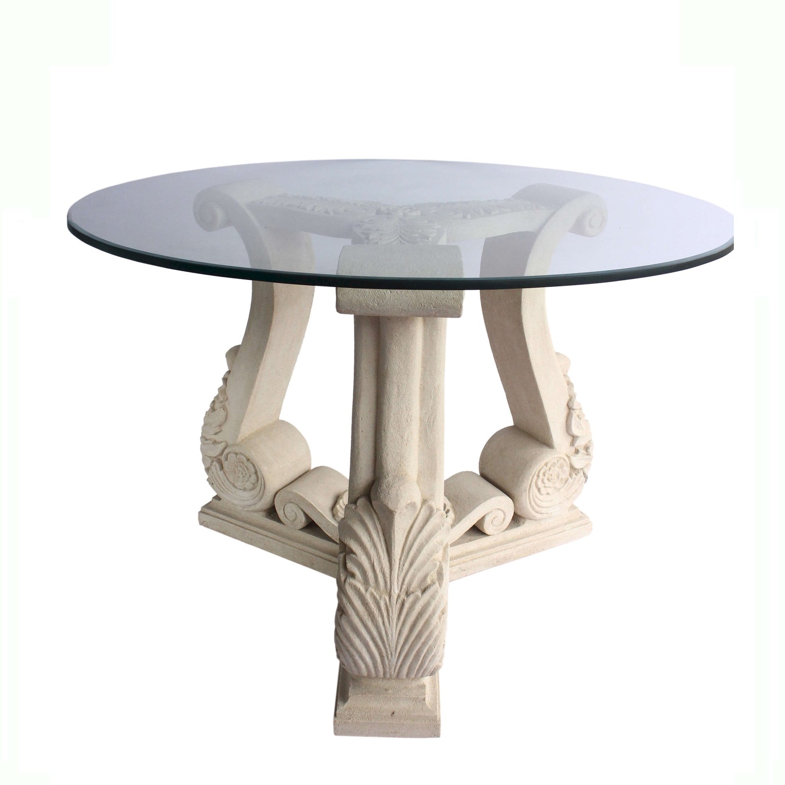 Round glass-top table with decorative white legs on a white background