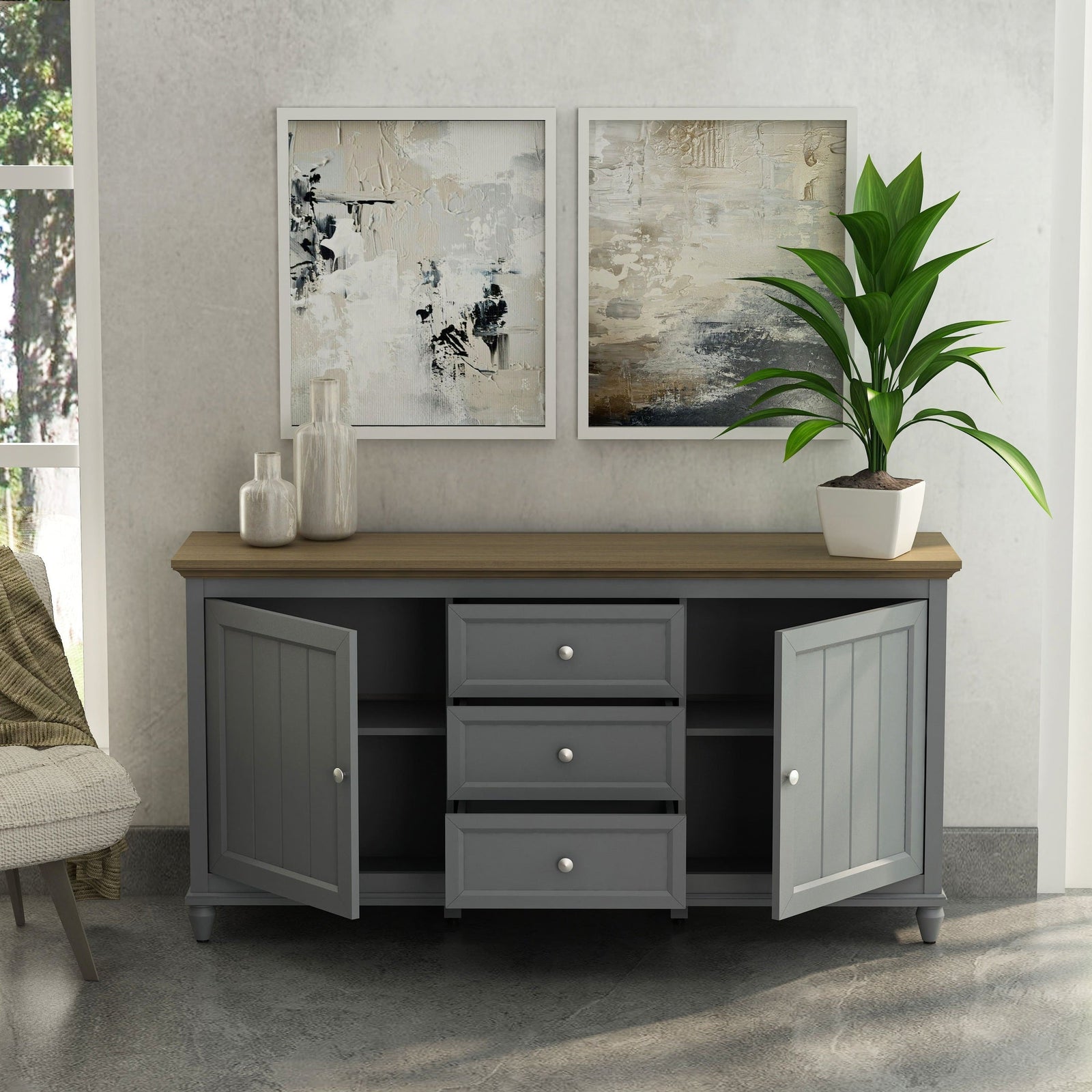 Gray sideboard with wooden top in a room with abstract art and a plant.