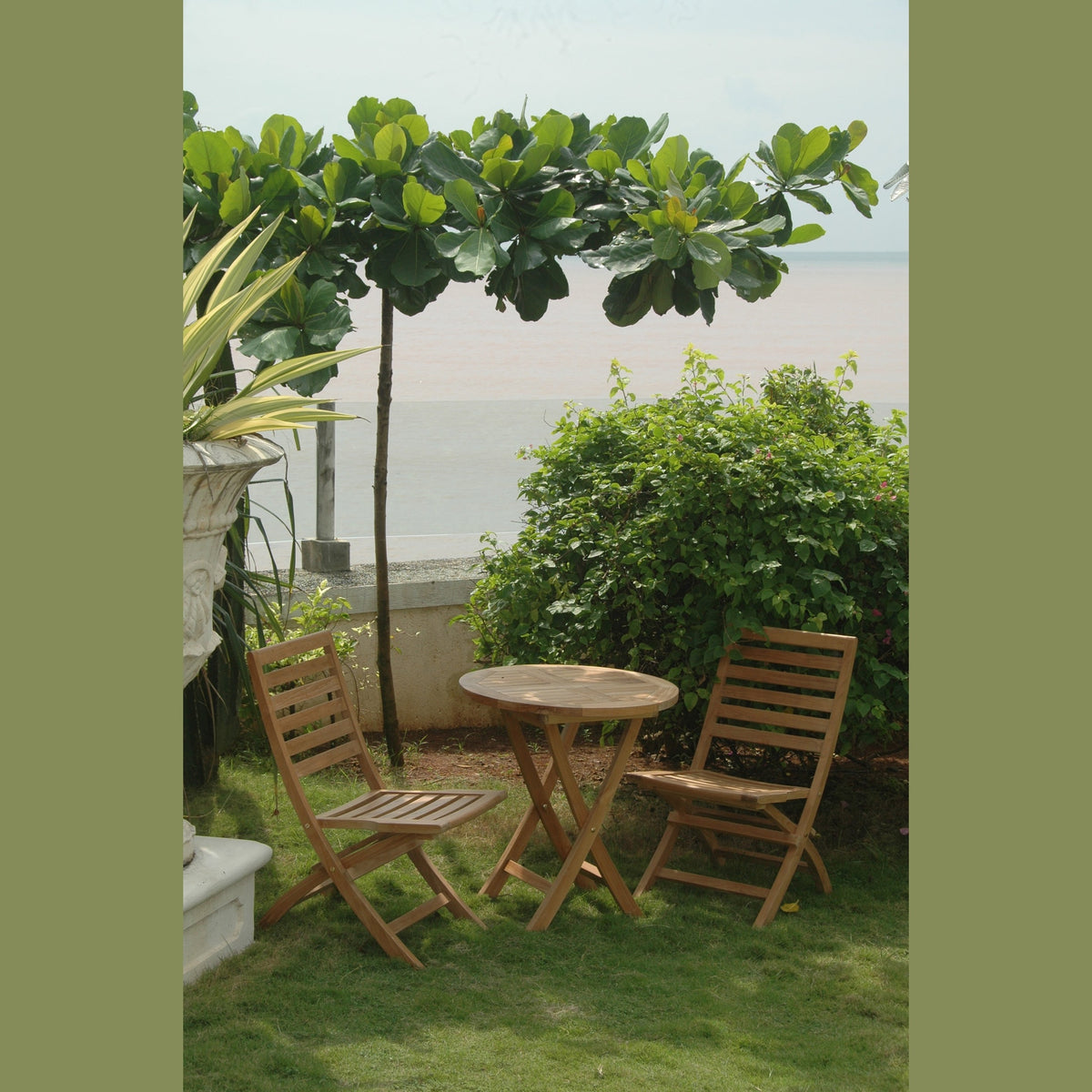 Wooden outdoor table and chairs with a scenic view of water and greenery.