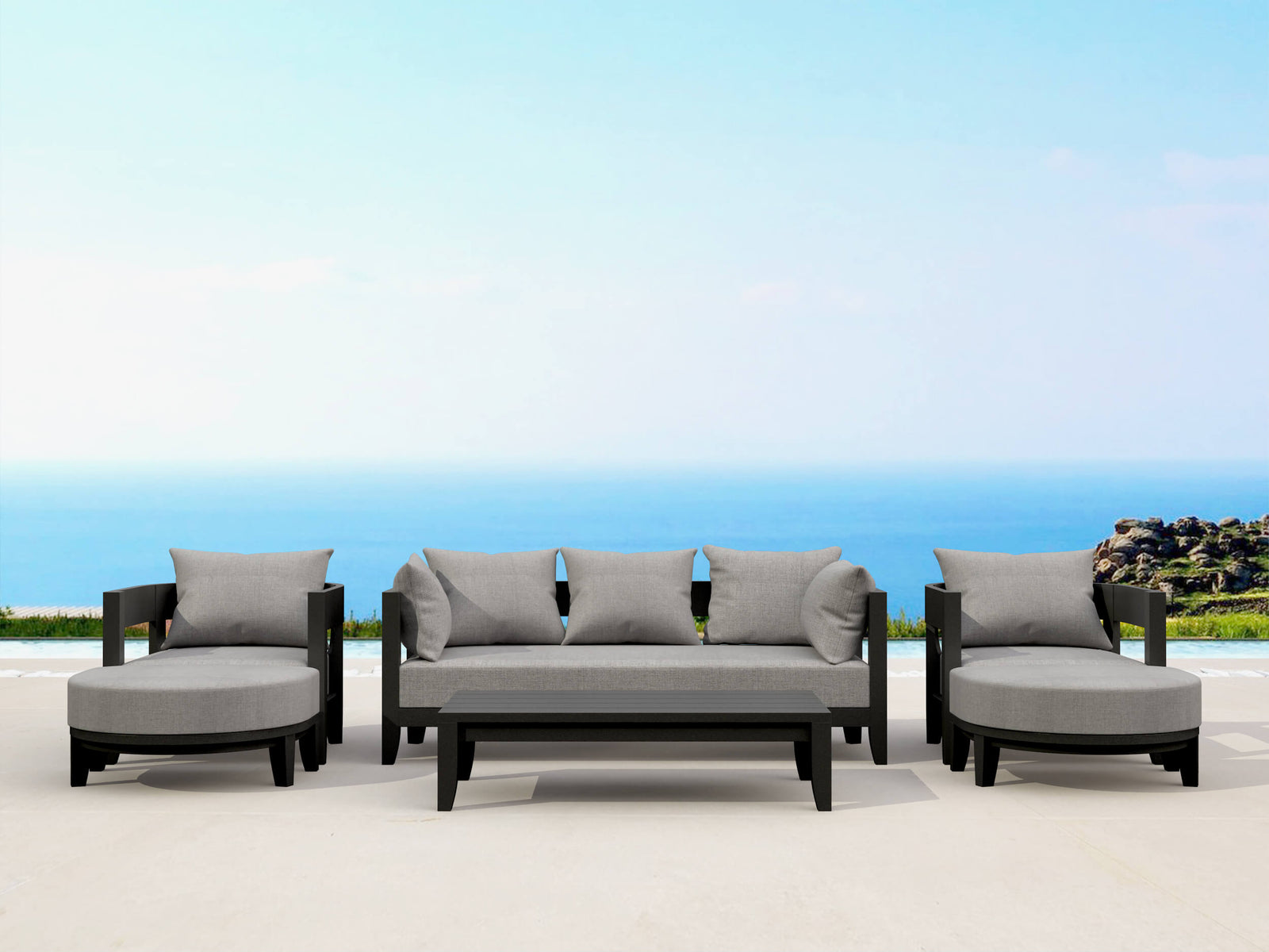 Outdoor patio furniture set with gray cushions against a blue sky and ocean backdrop.