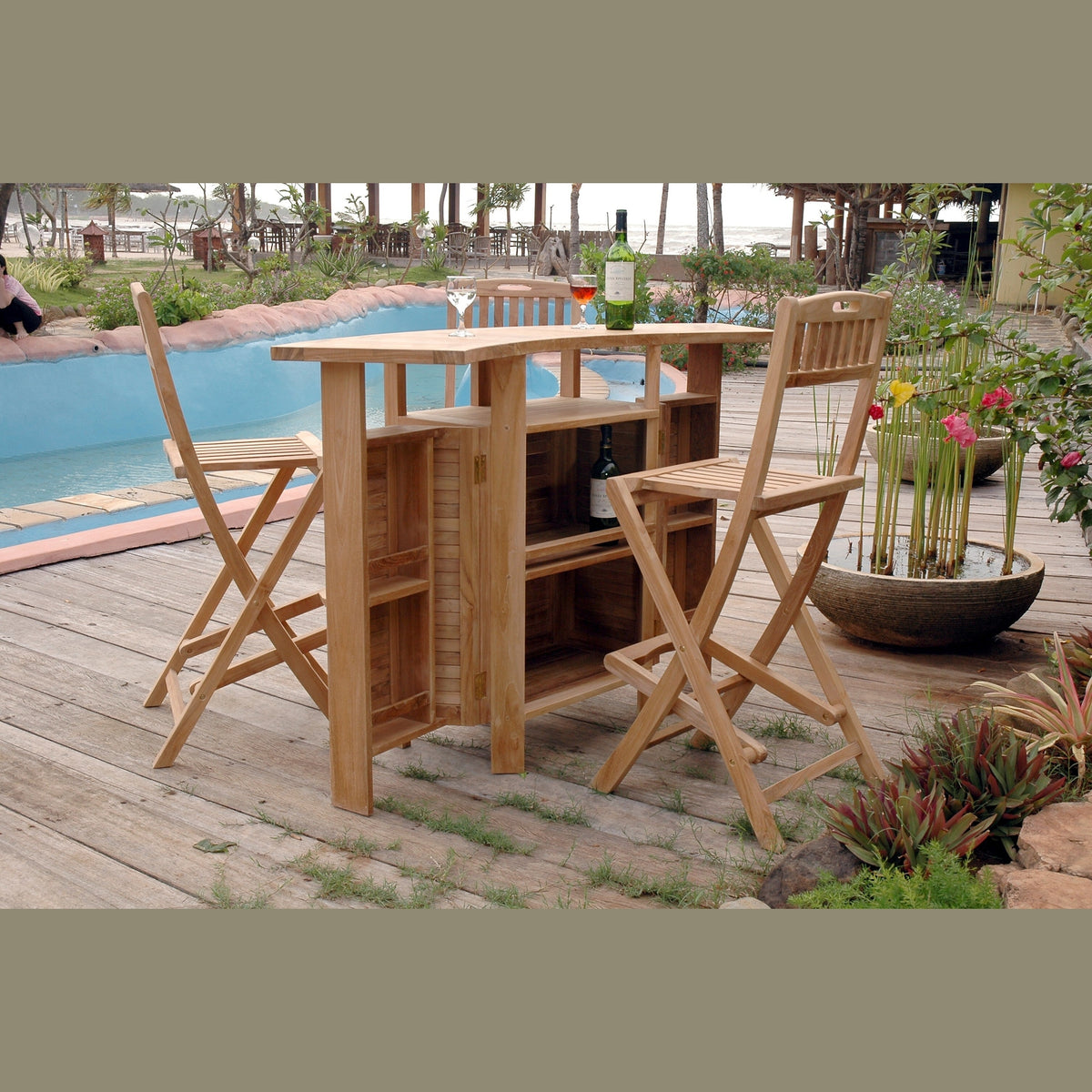 Wooden outdoor bar set with stools on a patio near a pool