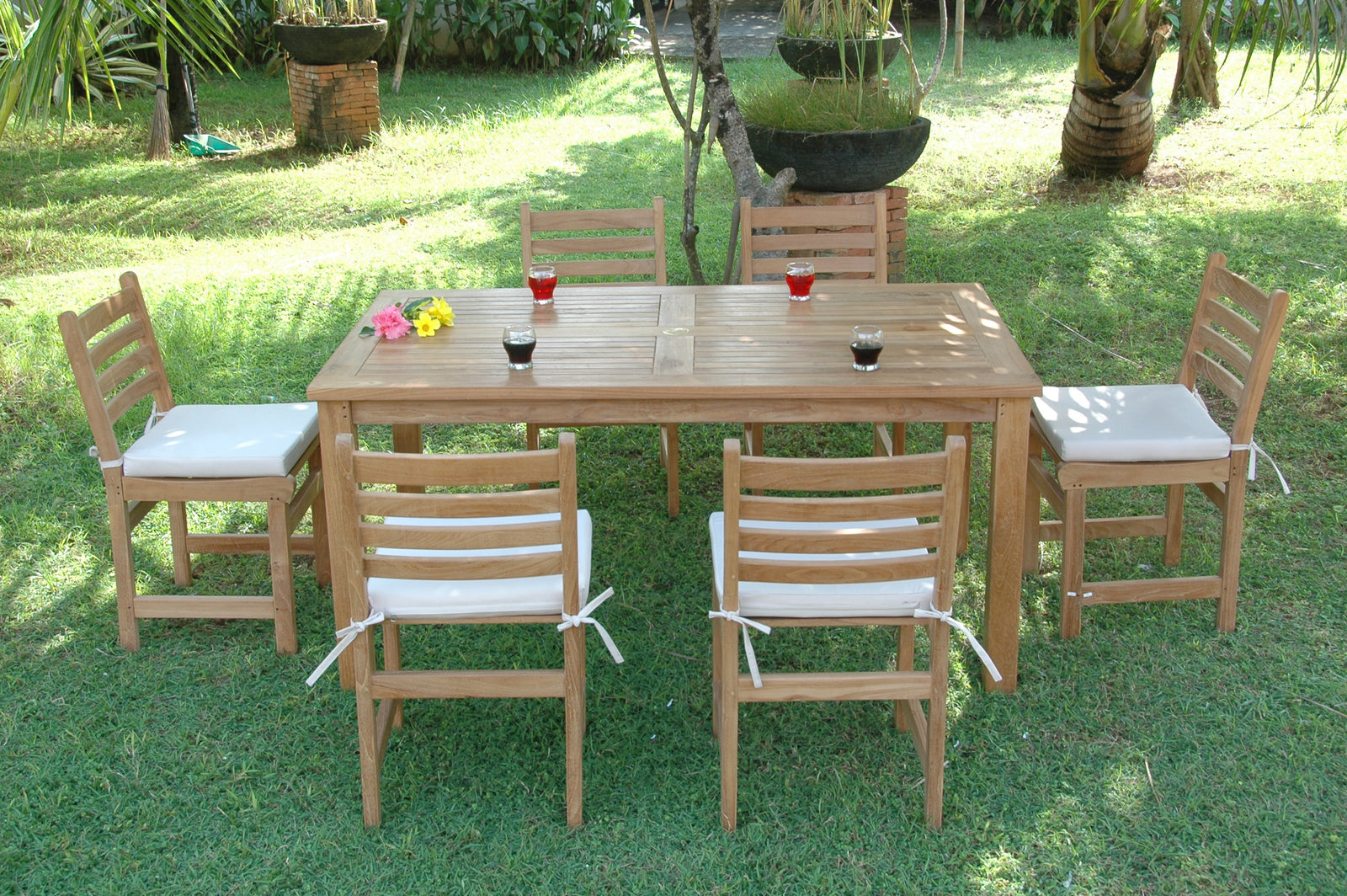 Wooden outdoor dining set with chairs and table on grass