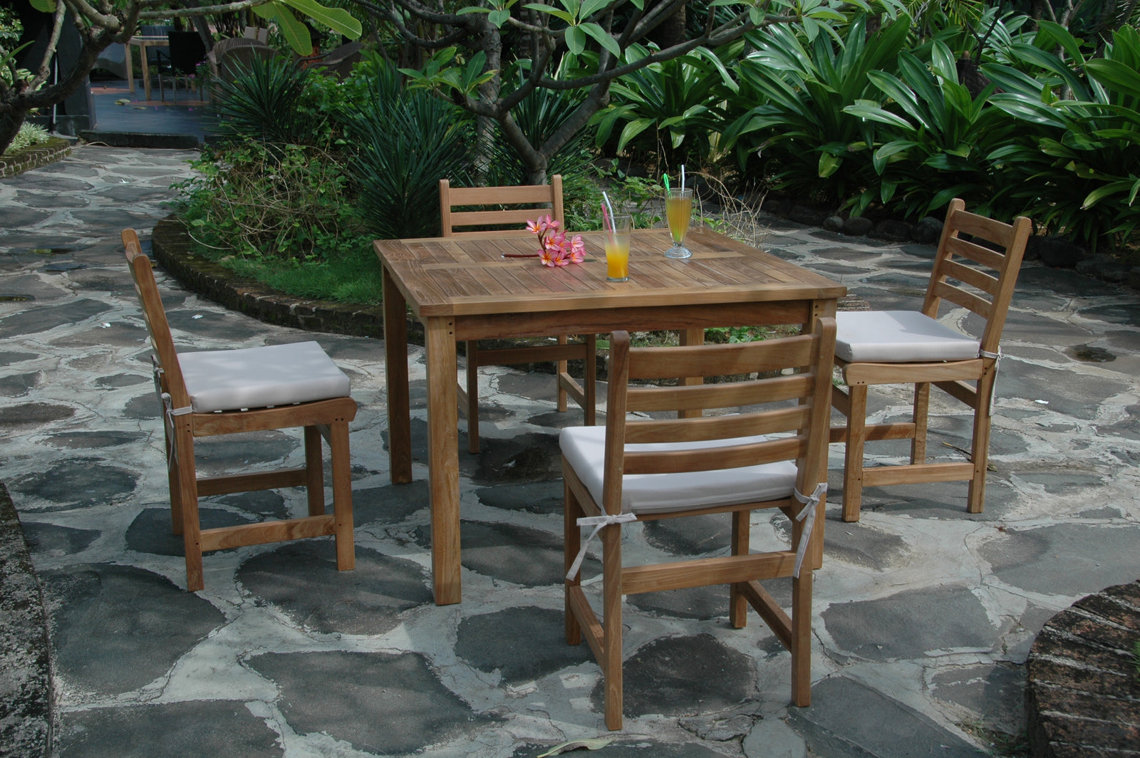 Wooden outdoor dining set with chairs and table on a stone patio