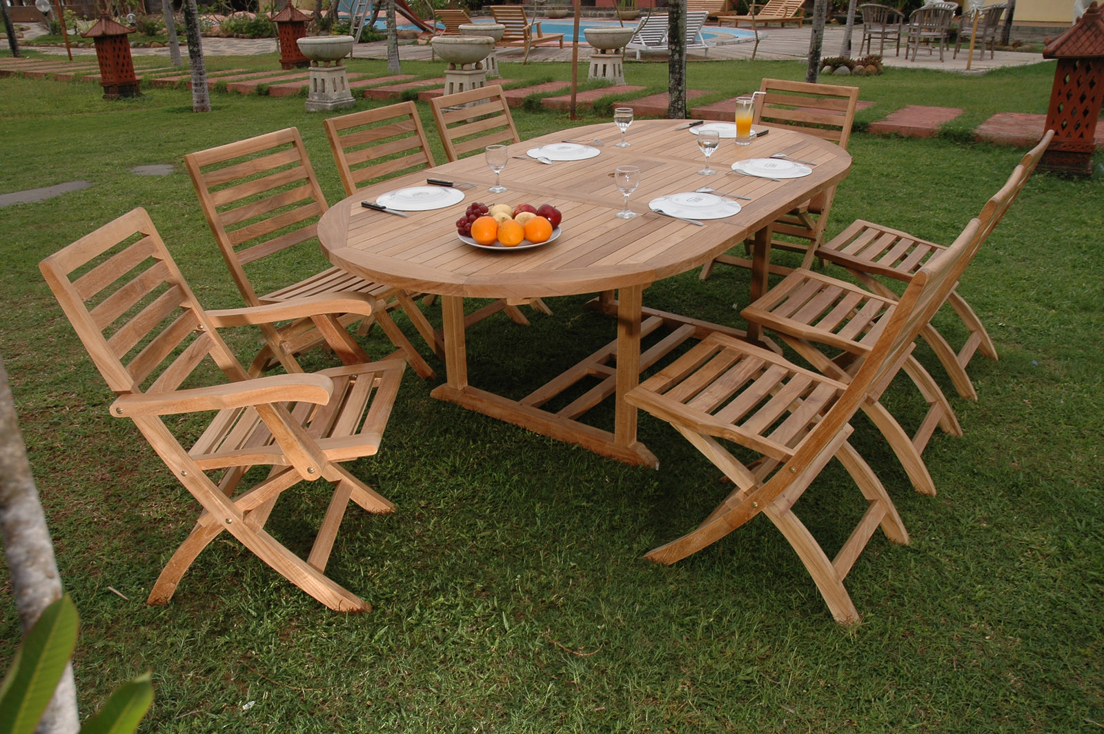 Wooden outdoor dining set with table and chairs on grass