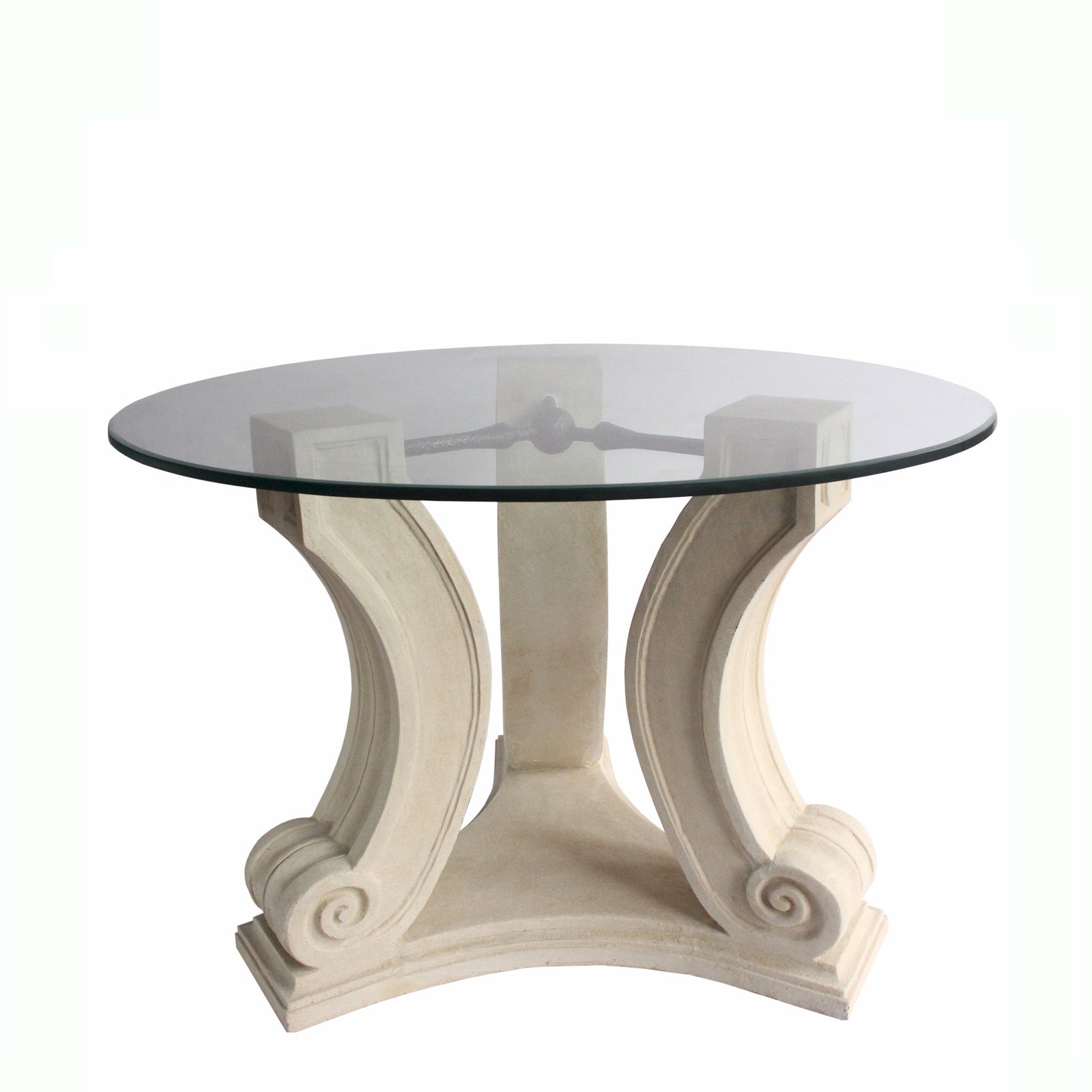 Round glass table with decorative white base on a white background