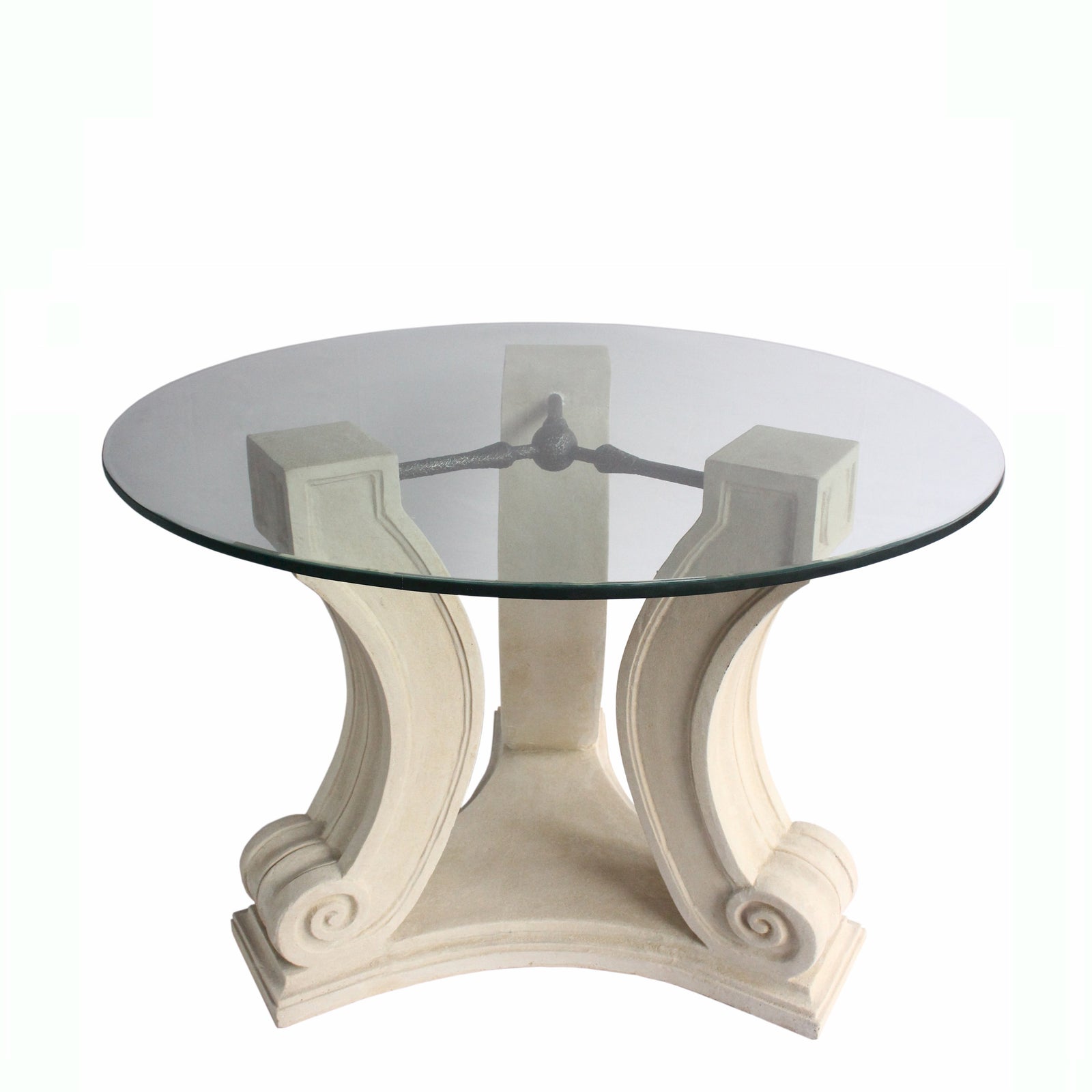 Round glass table with decorative white base on a white background