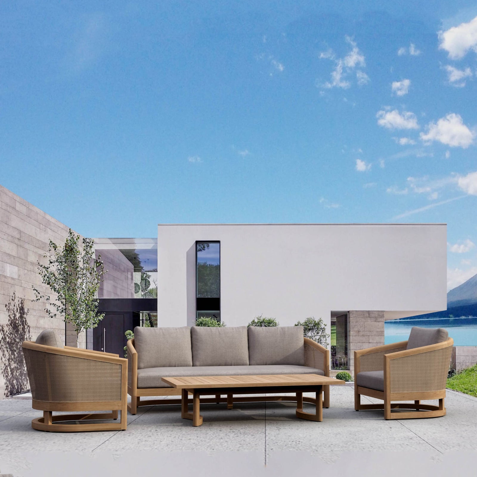 Outdoor patio set with sofa, chairs, and table against a blue sky.