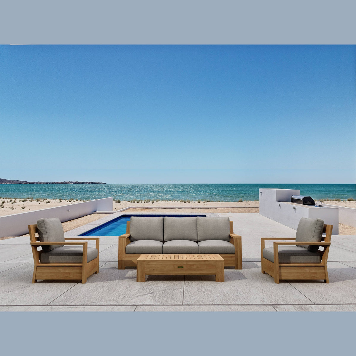 Outdoor furniture set with beige cushions by a pool and ocean view