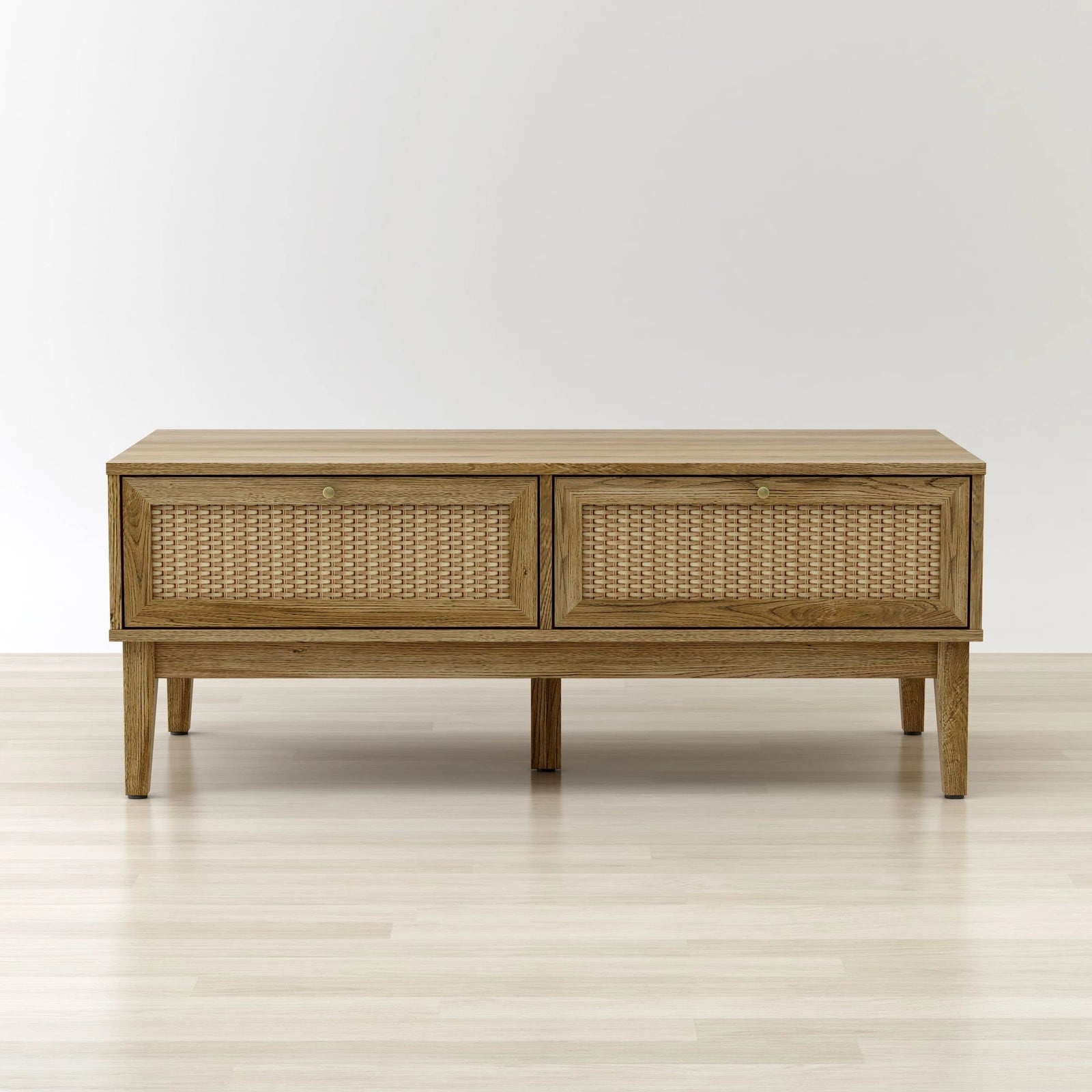 Wooden console table with wicker doors on a light wooden floor and white background