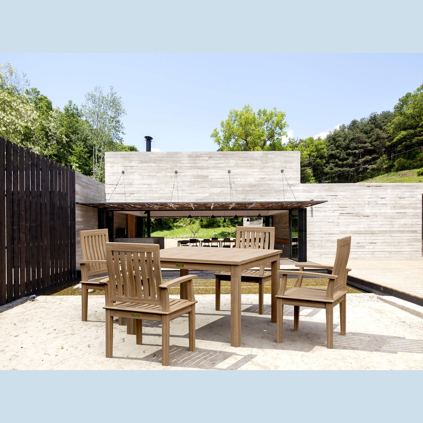 Outdoor wooden dining set with chairs on a patio area.