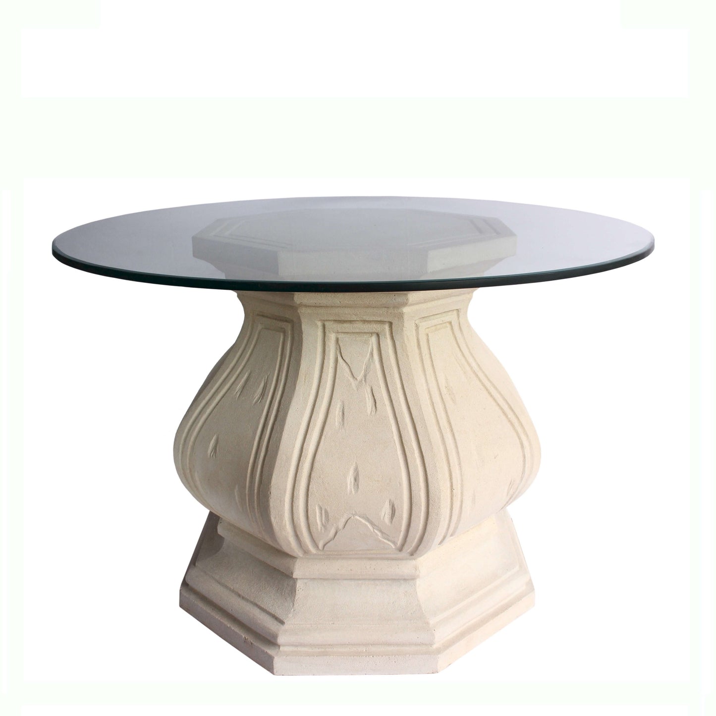 Round glass-top table with decorative beige base on a white background