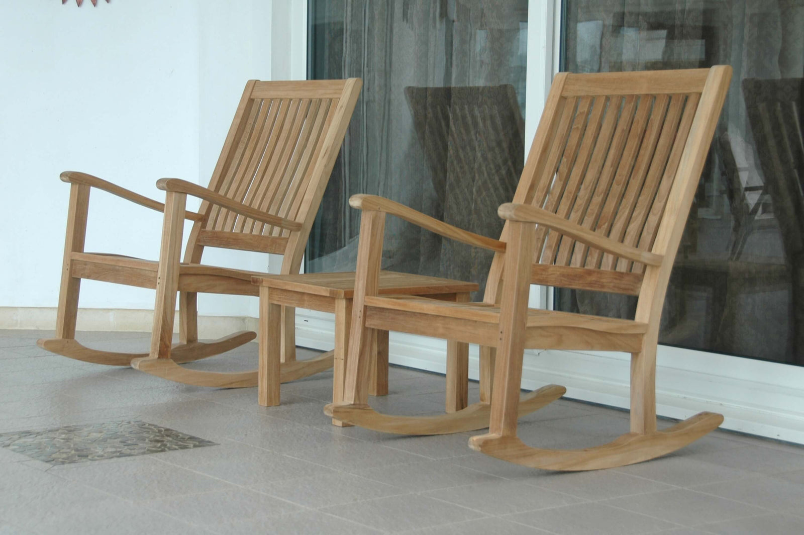 Two wooden rocking chairs on a patio