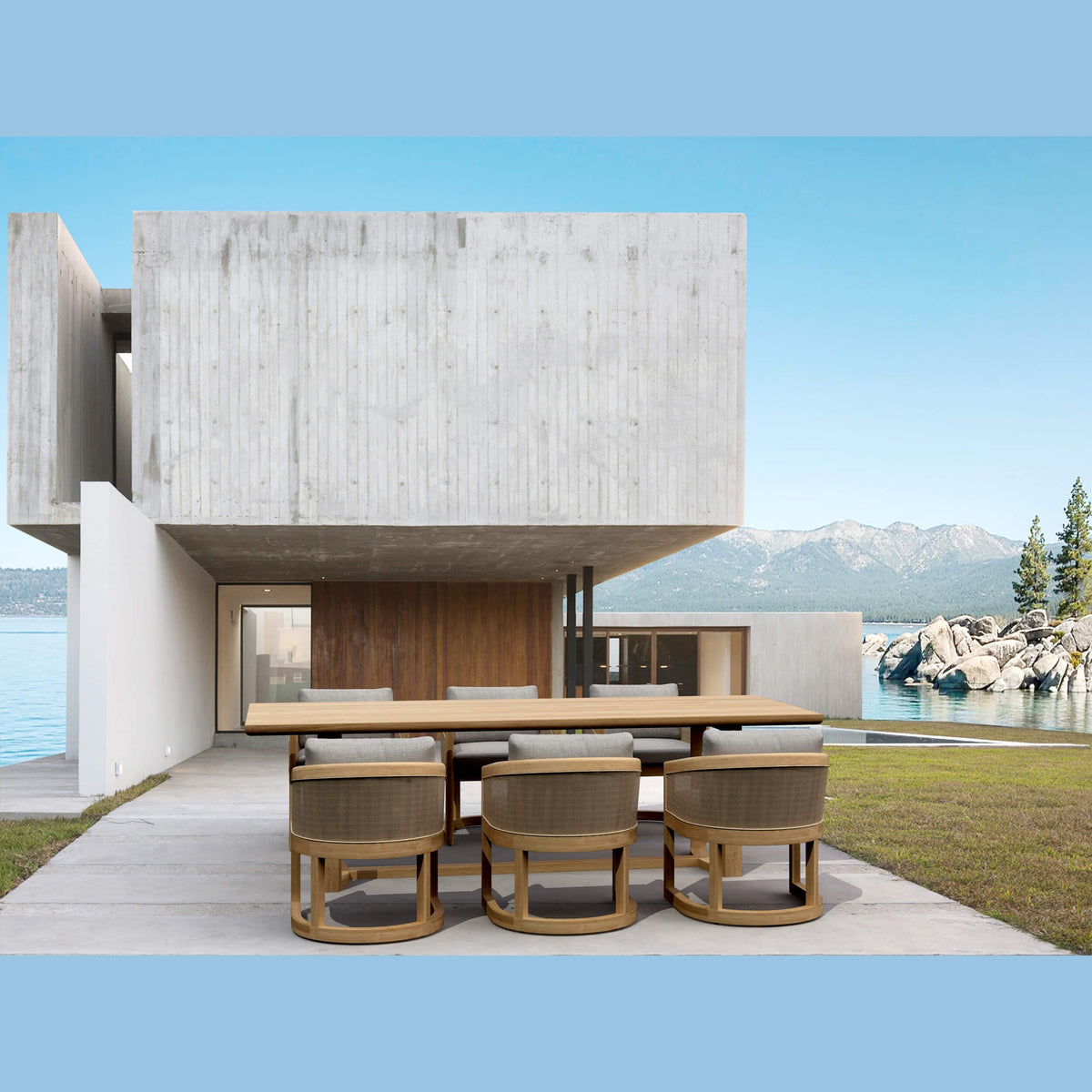 Modern house with a dining table and chairs by a waterfront