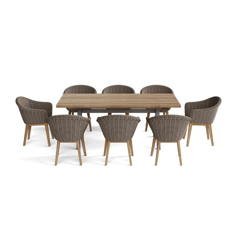 Wooden dining table with eight wicker chairs on a white background