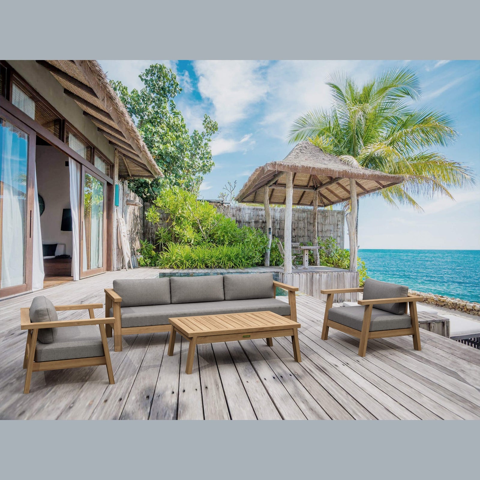 Outdoor seating area with wooden furniture on a deck overlooking the ocean.