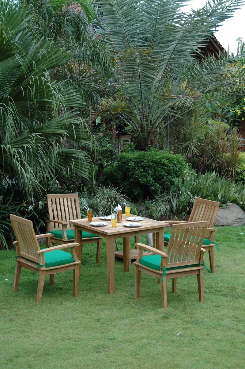 Outdoor dining set with wooden chairs and table in a garden setting
