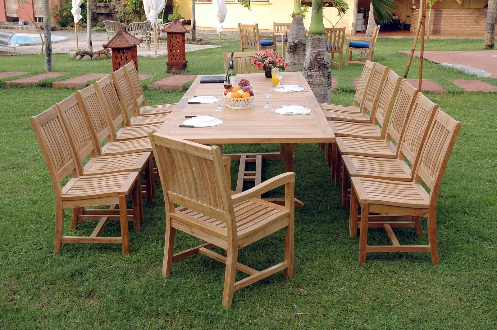 Wooden outdoor dining set with table and chairs on a grassy area