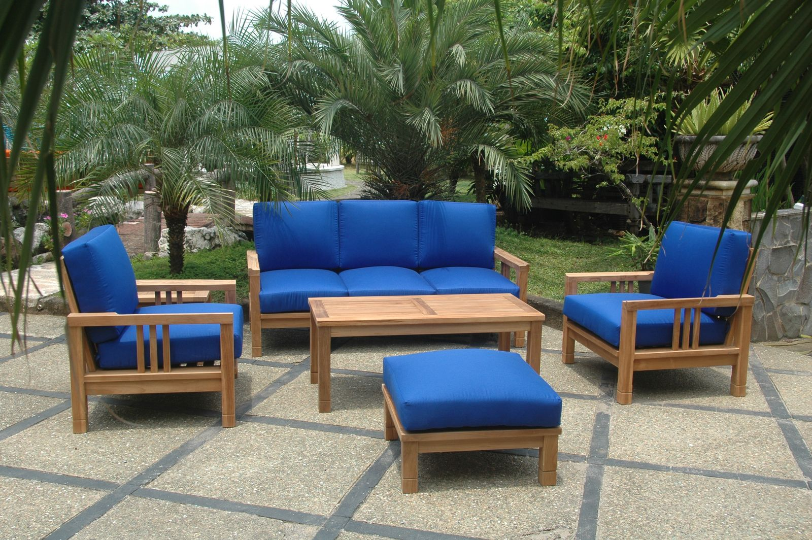 Outdoor furniture set with blue cushions on a patio