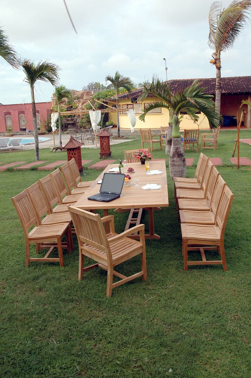 Outdoor wooden dining set with table and chairs on a grassy area