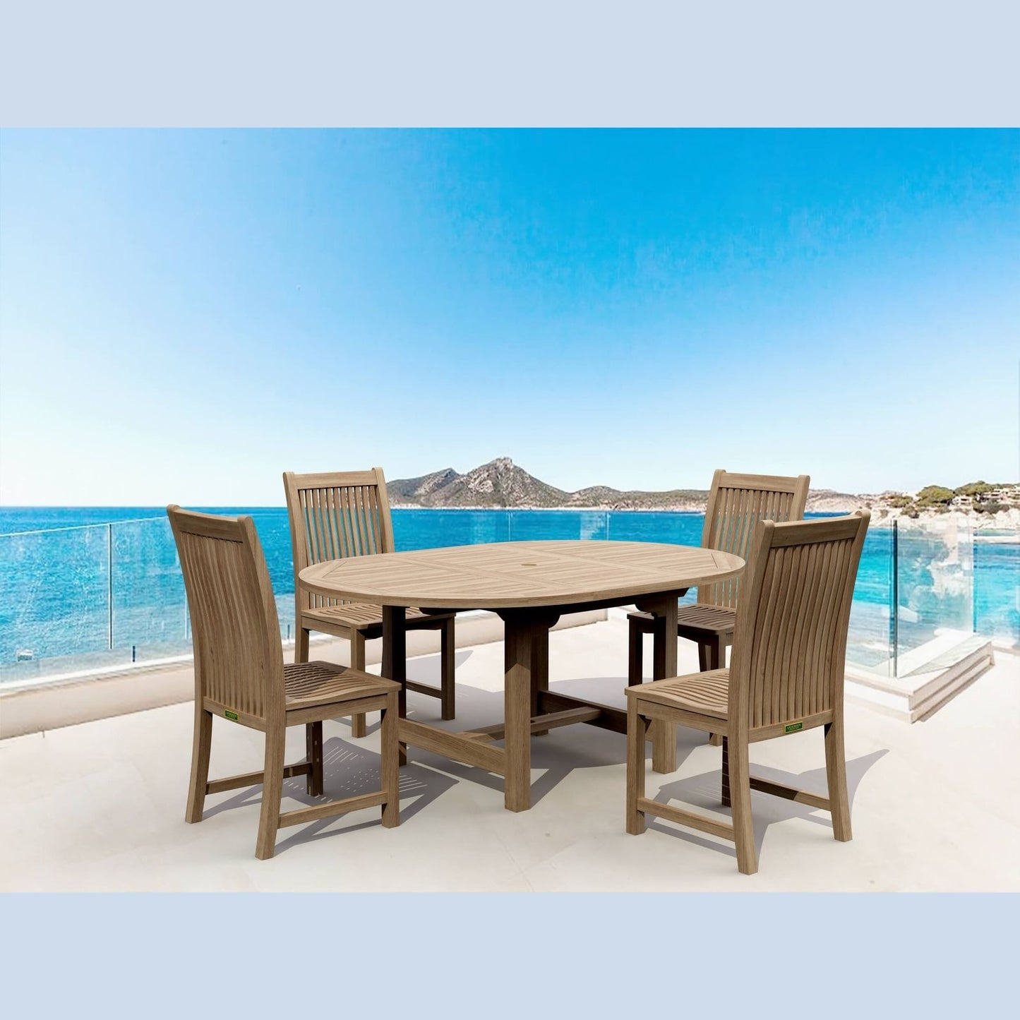 Outdoor dining set with table and chairs on a balcony with a scenic view of water and mountains.