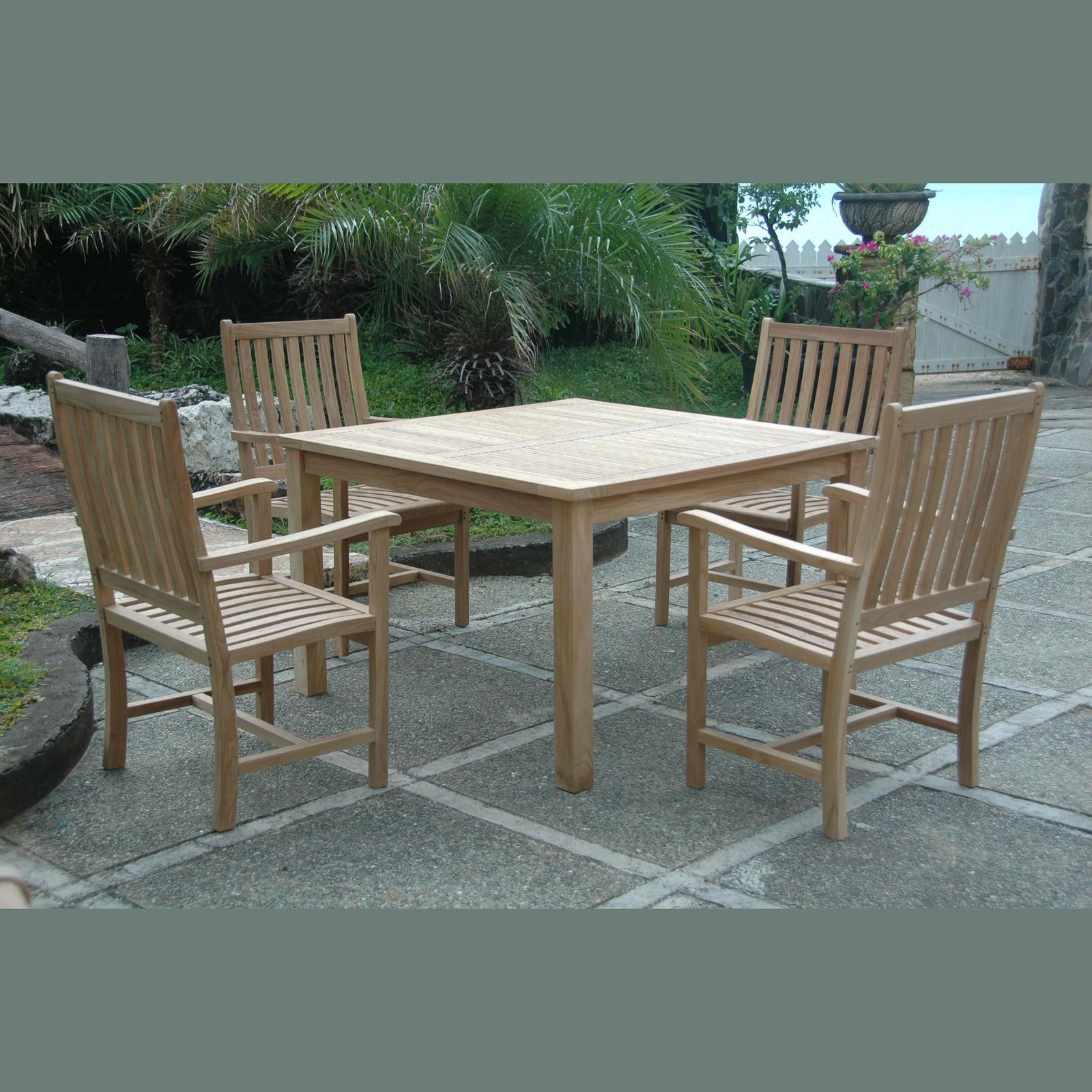Wooden outdoor dining set with table and chairs on a stone patio