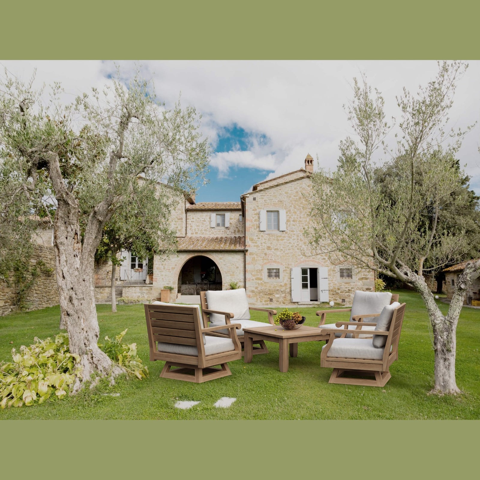 Outdoor furniture set on a grassy area with a stone building in the background