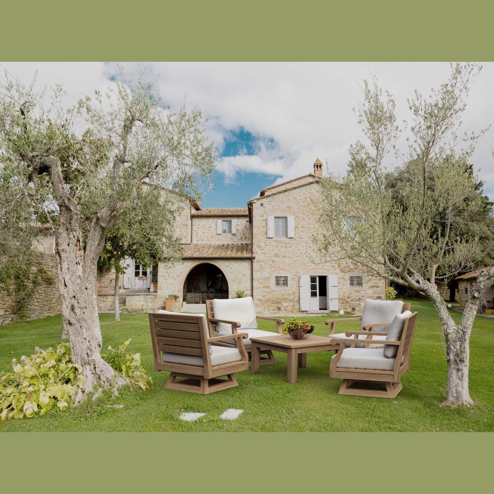Outdoor furniture set on a grassy area with a stone building in the background