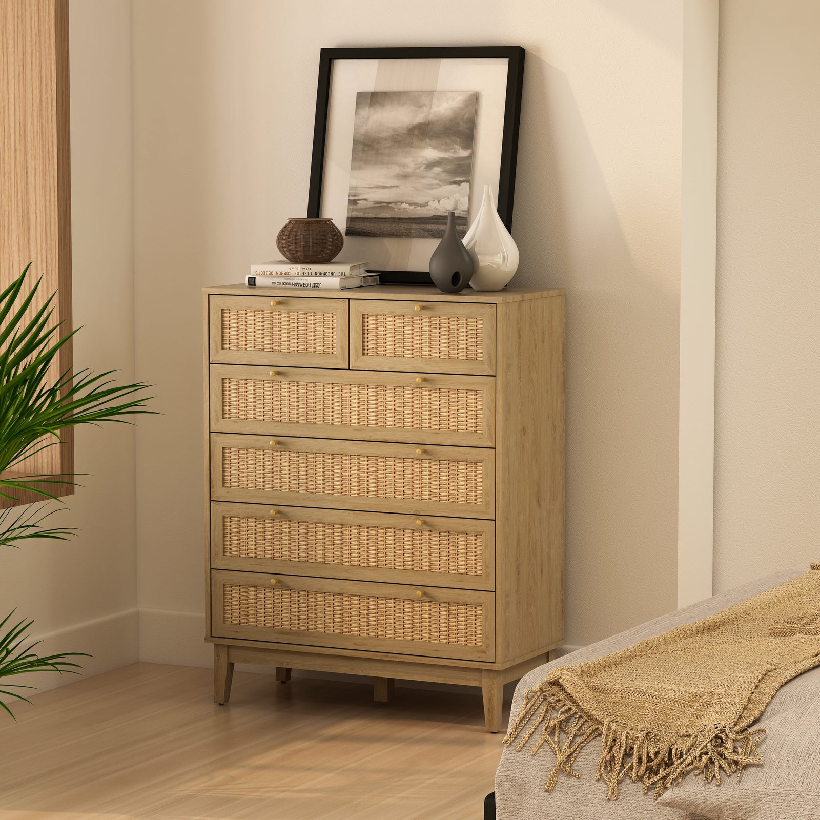Wicker chest of drawers in a bedroom setting with decor elements.