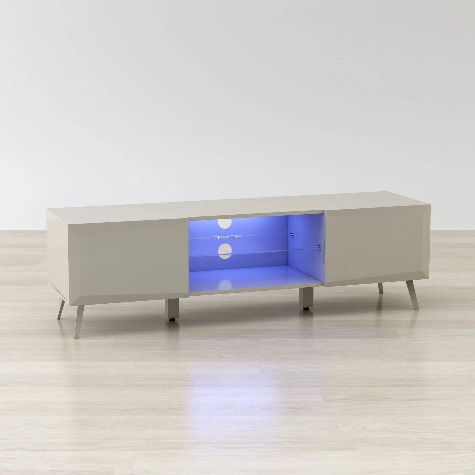 White entertainment console with glowing blue interior on a white floor and background