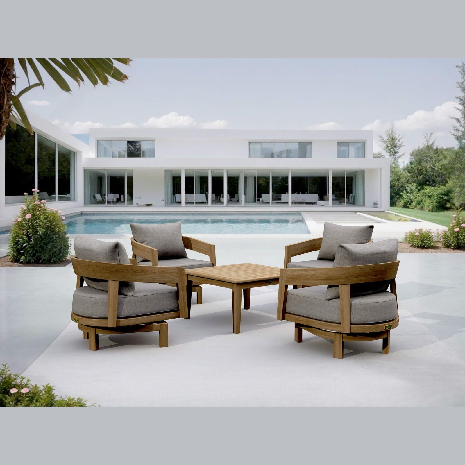Outdoor patio set with wooden chairs and table in front of a modern house.