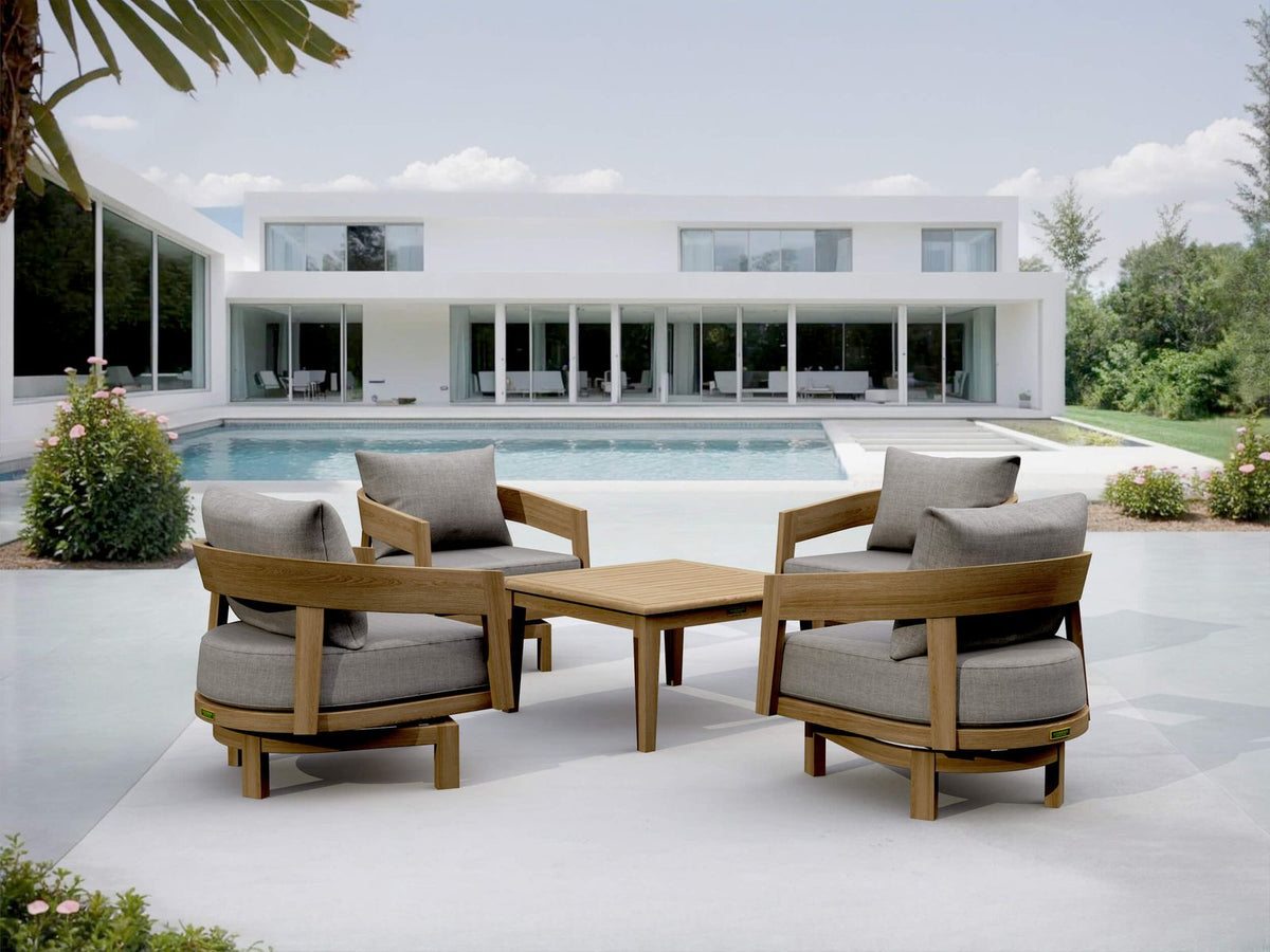 Outdoor patio set with wooden chairs and table in front of a modern house.