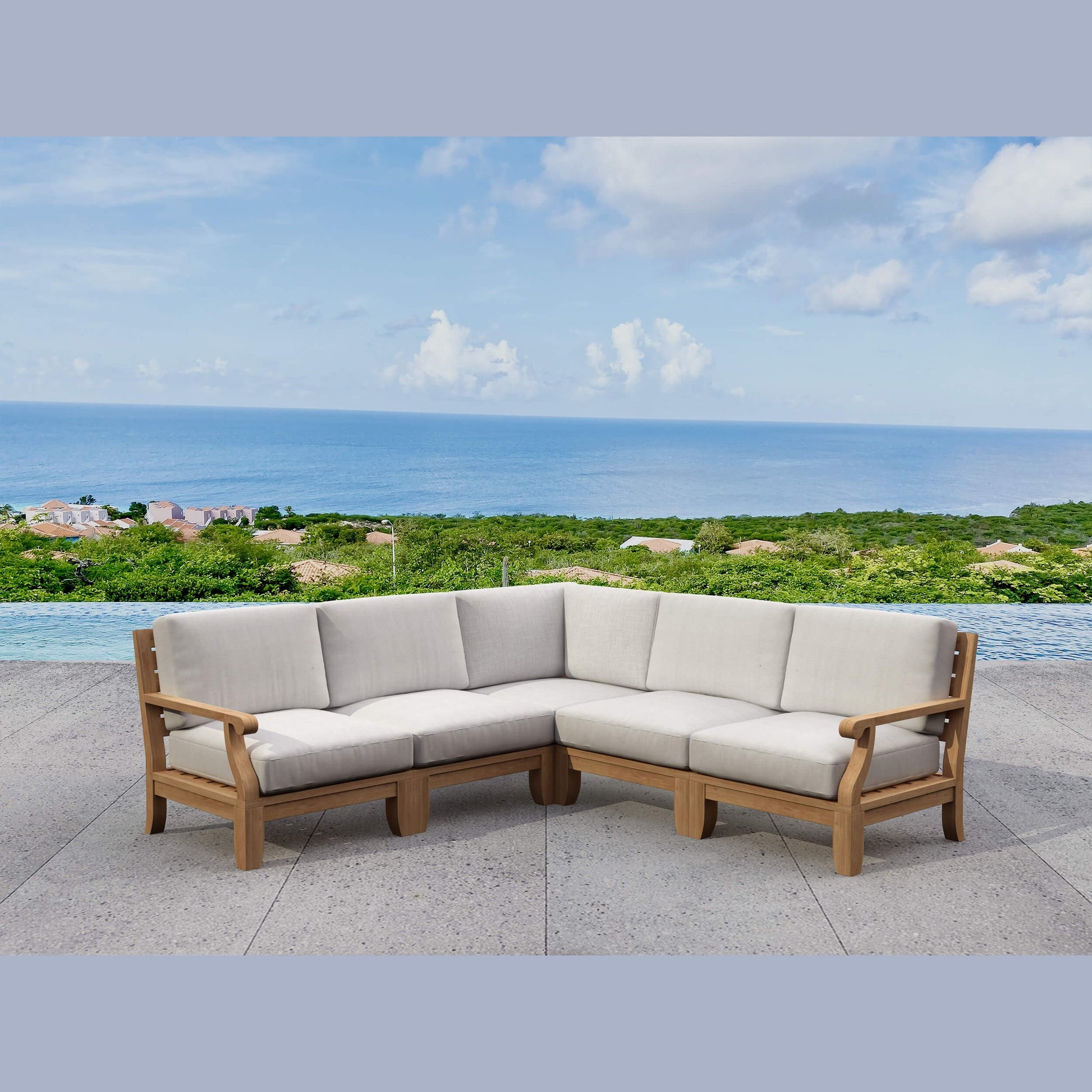 Outdoor sectional sofa with beige cushions on a patio overlooking the ocean.