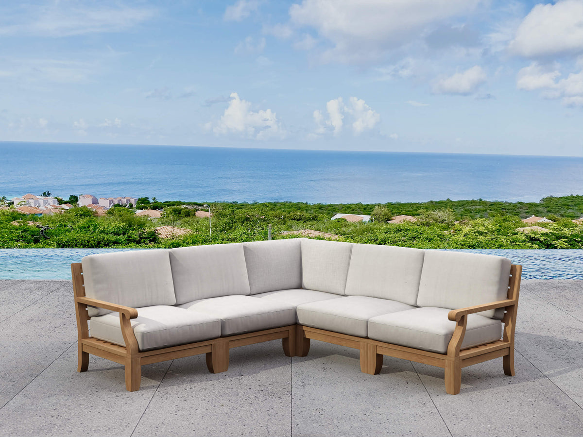 Outdoor sectional sofa with beige cushions on a patio overlooking the ocean.
