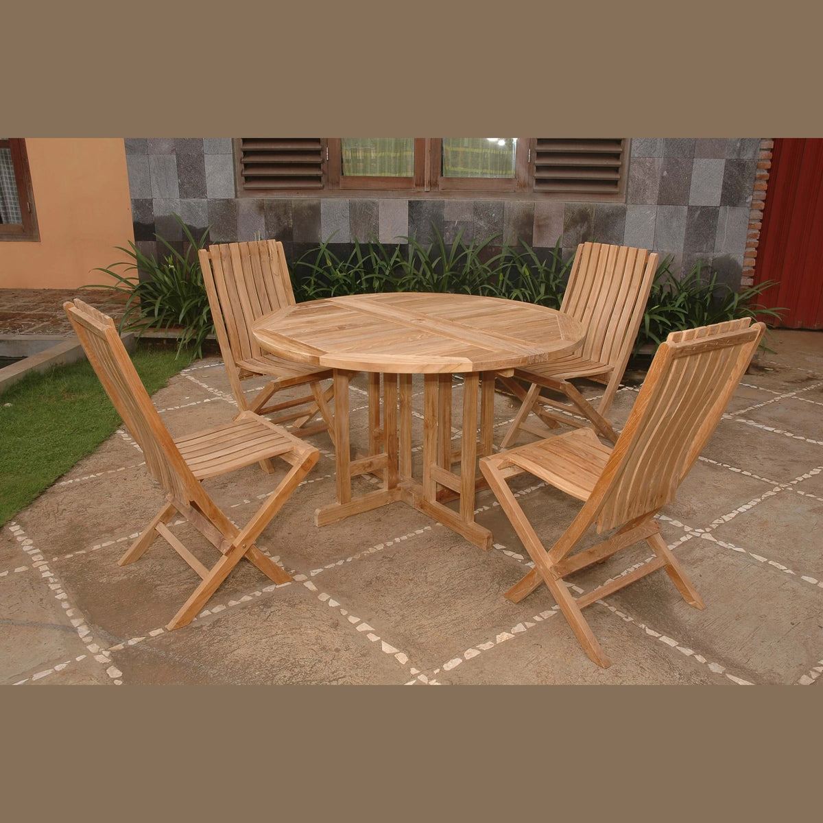 Wooden outdoor dining set with table and chairs on a stone patio.