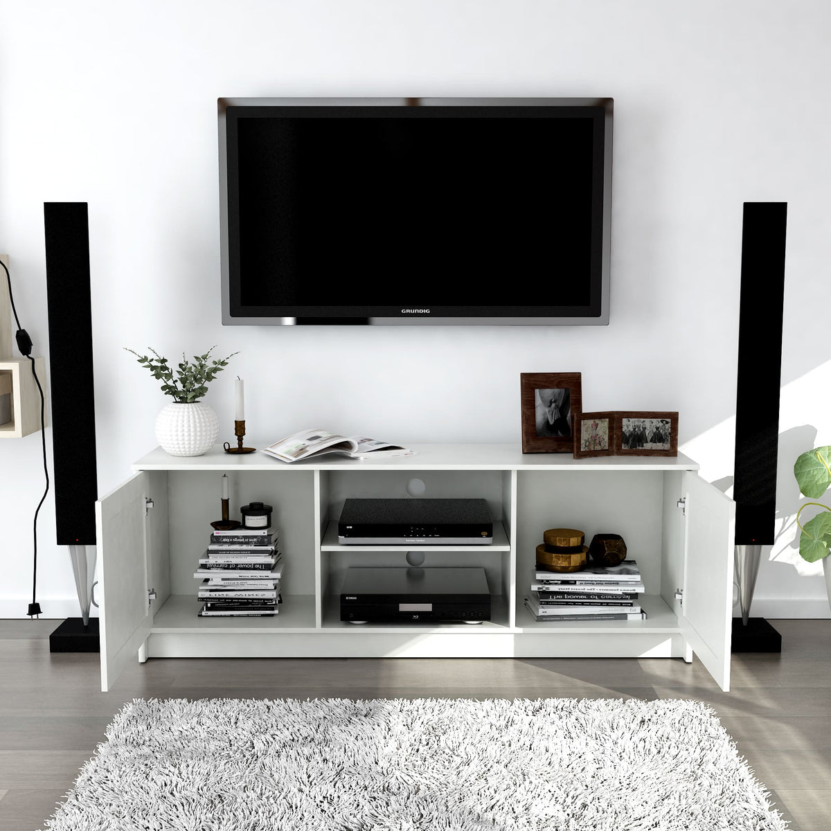 Modern living room with a white entertainment console, TV, and decorative items.